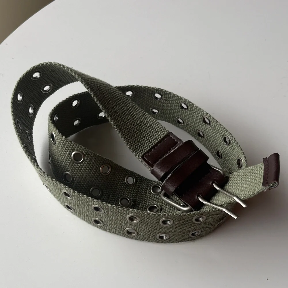 Olive Green Canvas Belt with brown accents. Silver tone hook loops.